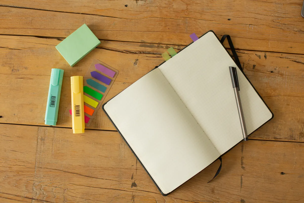 Sample image: An open notebook with highlighters on a wooden table